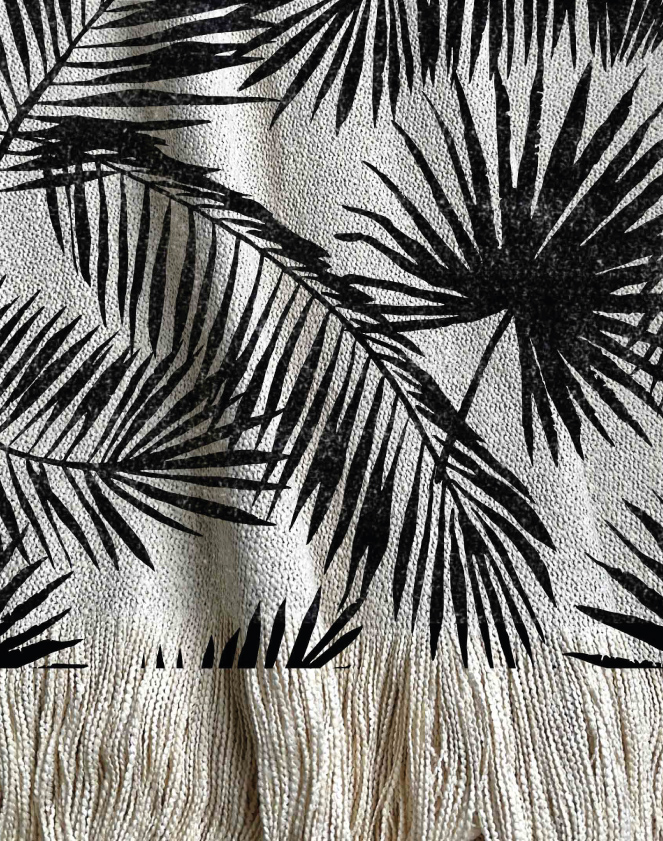Manta tejida diseño botánico de distintos tipos de hojas tipo palmera en color negro.