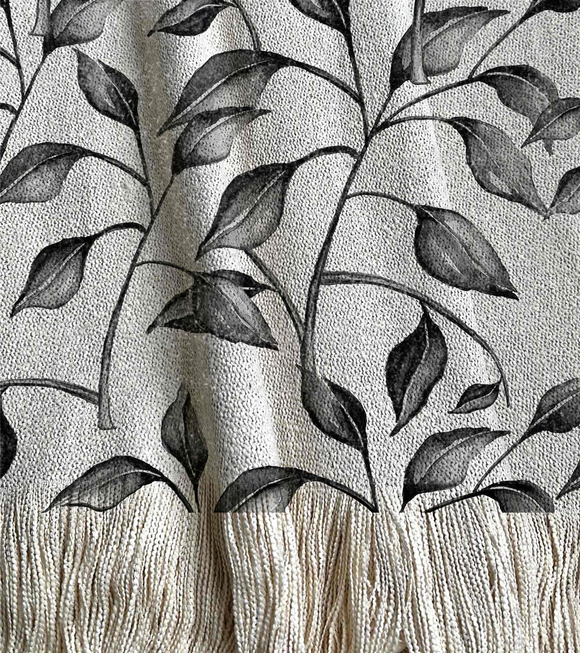 Manta tejida con un diseño botanico, hojas y ramas de acuarela